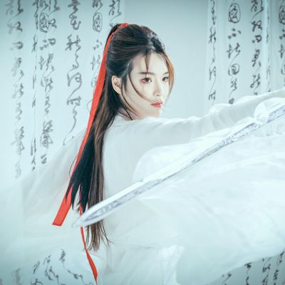 A woman in a flowing yoga warrior pose.